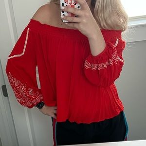 Orange/red top with white crochet. Size M. Worn once. Can be on or off shoulder.
